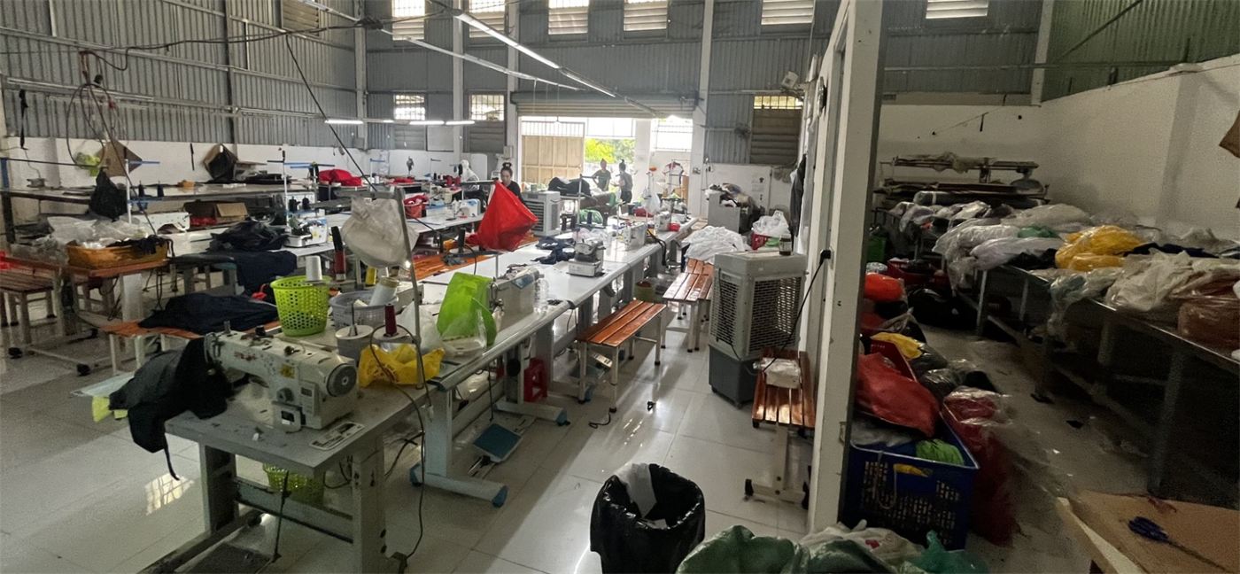 Garment workshop with sewing machines and material bins