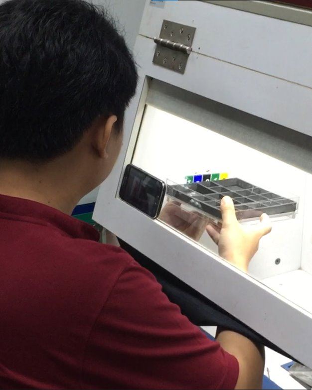 Worker scanning parts with a smartphone